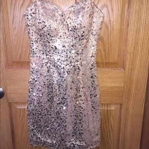 Gold sequence strapless formal dress.